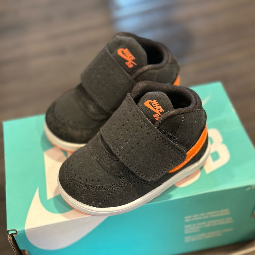 Size 2 baby.  Orange and Grey Nike